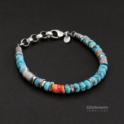 Oxidised sterling silver bracelet with blue turquoise and orange spiny oyster beads on a dark background