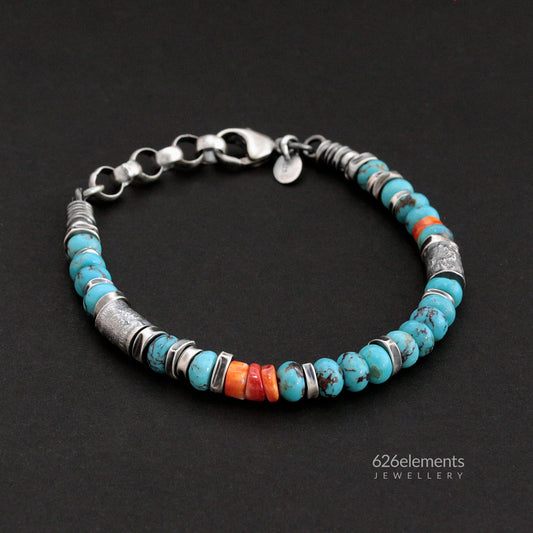 Oxidised sterling silver bracelet with blue turquoise and orange spiny oyster beads on a dark background